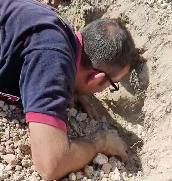 As he worked to free the dog, he picked ...