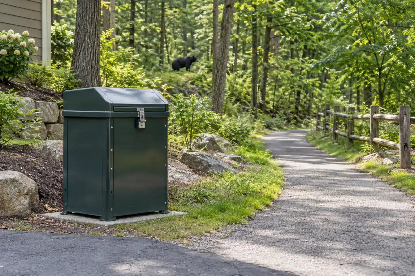 Bear-resistant trash container near wooded homes, illustrating conflict-prevention measures