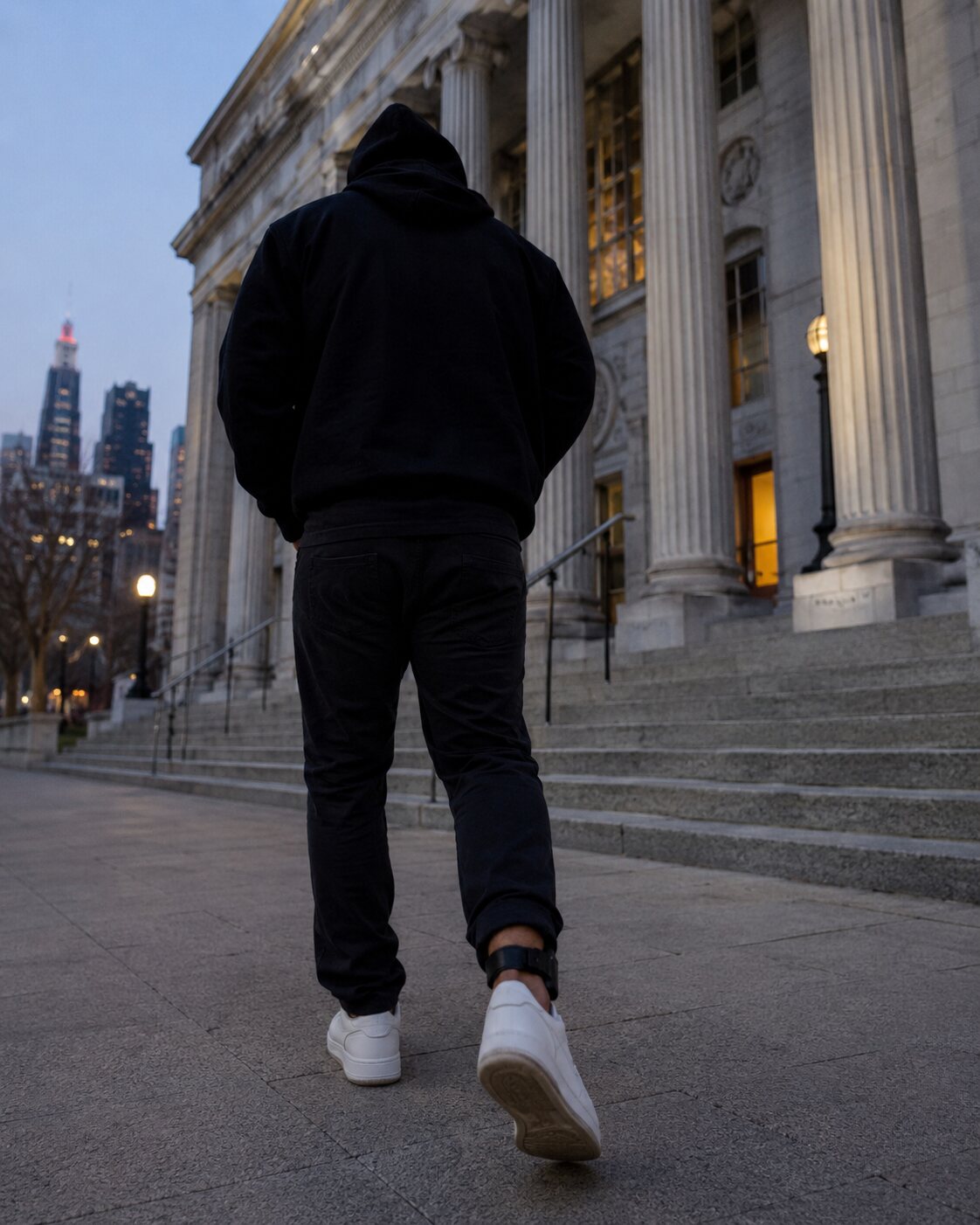A non-identifiable person wearing an ankle monitor outside a courthouse