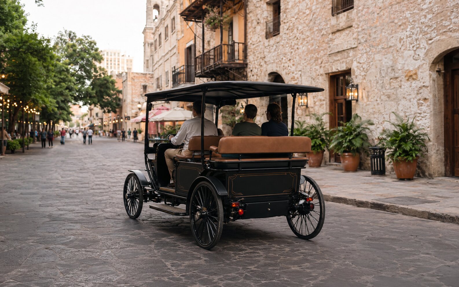 A horseless battery-powered carriage on a historic downtown street