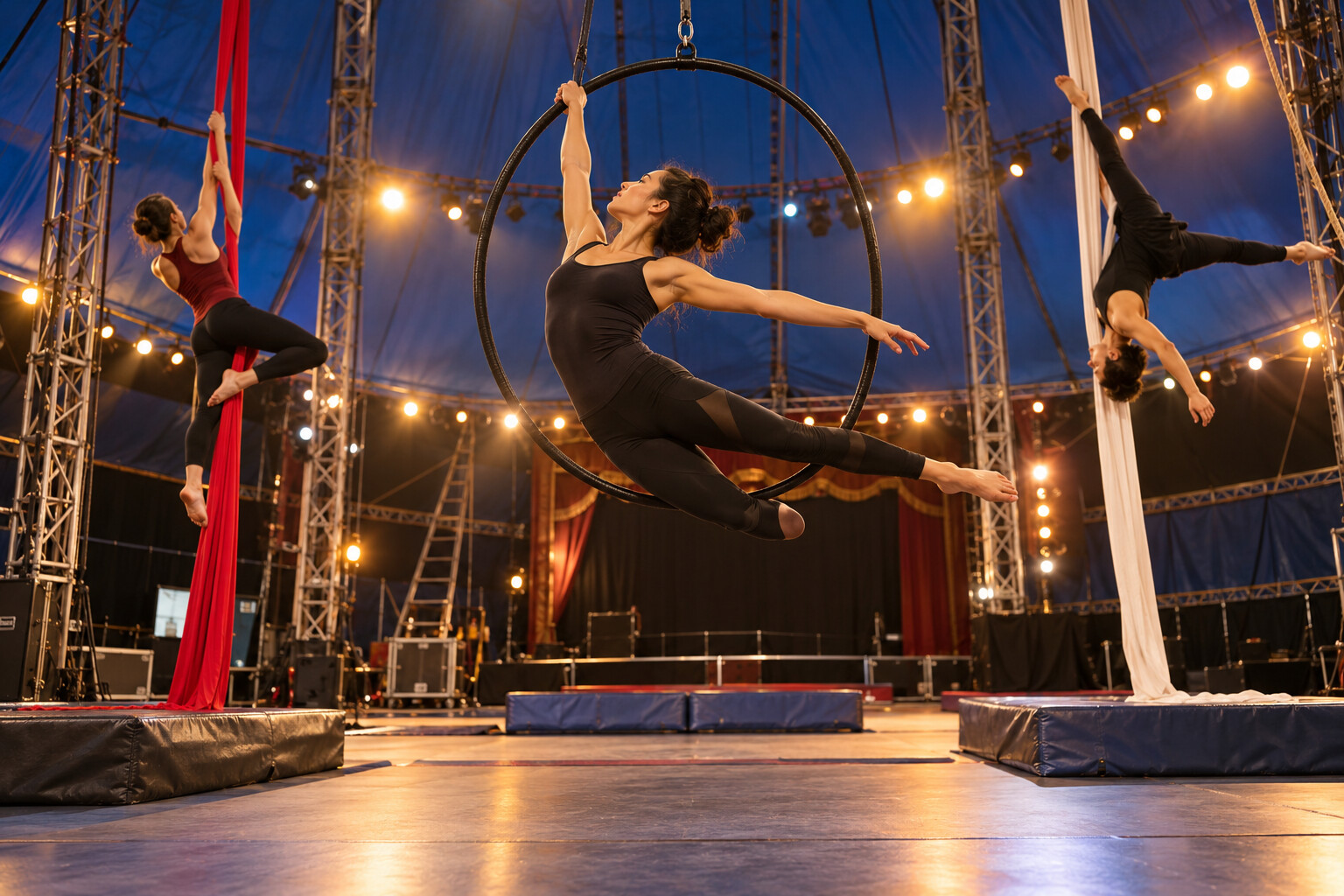 Aerial acrobats rehearsing in an animal-free circus ring